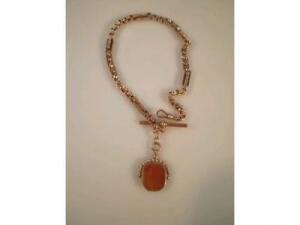 A fancy link Albert, stamped 9ct with a double agate faced fob attached,