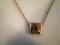A 9ct gold belcher chain attached to a square agate panelled pendant