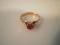 A 22ct gold wedding band converted to be set with a single claw set pink stone