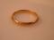 A plain 22ct gold wedding band