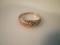 A tiny diamond set twist ring stamped 9ct