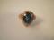 A dress ring, a tear drop shaped blue topaz surrounded by tiny diamonds, shank stamped 18K