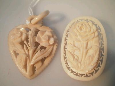 A carved ivory brooch and heart shaped pendant