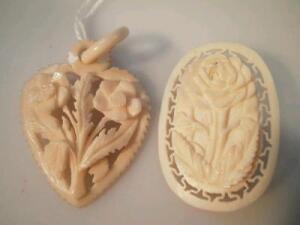 A carved ivory brooch and heart shaped pendant