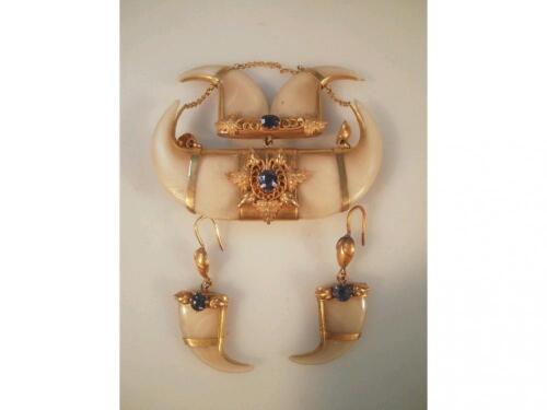 A tiger tooth brooch, scratched 15ct, set with blue stones, and a pair