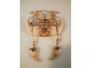 A tiger tooth brooch, scratched 15ct, set with blue stones, and a pair