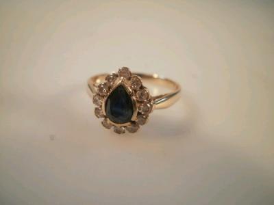 A tear drop shaped sapphire and diamond cluster dress ring