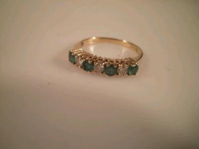 An emerald and diamond set ? hoop eternity ring