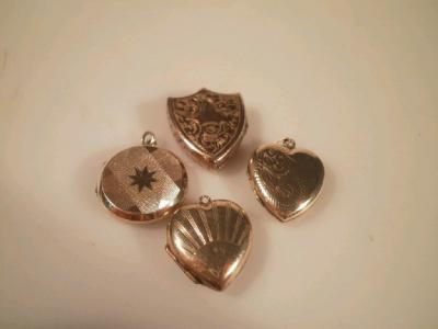 Four various yellow metal lockets