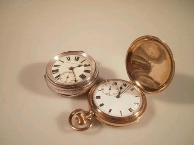 A gold plated hunter pocket watch with inscriptions and an open faced silver pocket watch