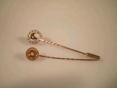 A horseshoe shaped seed pearl set stick pin and another set set