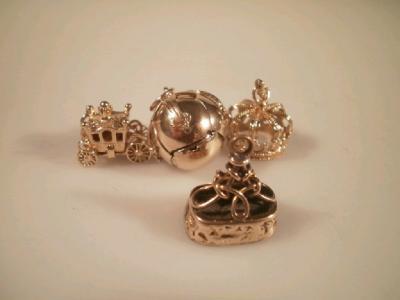 Four various bracelet charms marked for 9ct including a Masonic ball