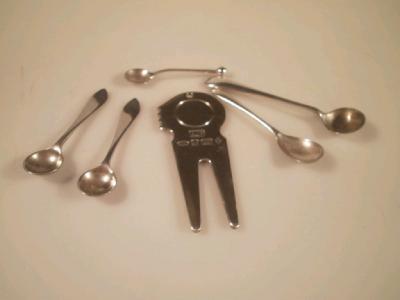 Five silver salt spoons and a silver divot repairer
