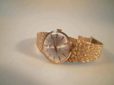 A lady's Movado mid size 9ct gold bracelet watch