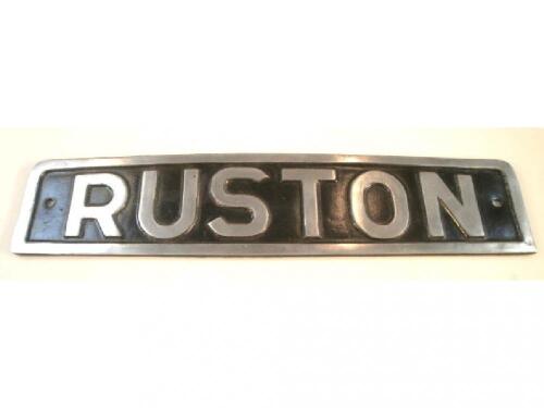 A cast metal engine plaque Ruston on black ground