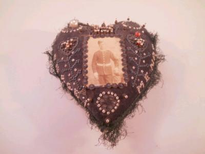 A Victorian sweetheart pin cushion with a Victorian sweetheart forget-me-not pin cushion