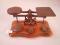 A set of large brass postal scales and a set of weights up to 1lb
