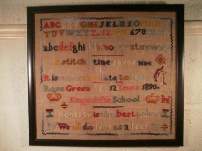 A needlework sampler, by Rose Green, aged 12, circa 1890, 58cm x 42cm, framed and glazed