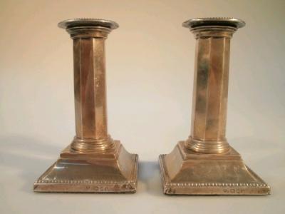 A pair of early George V silver boudoir candlesticks