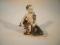 A Royal Copenhagen figure of a youth with trident on the back of a dolphin