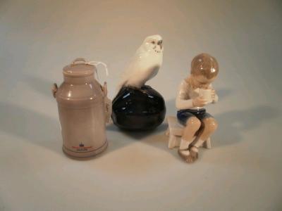 A Royal Copenhagen figure of a budgerigar seated on a large seed pod