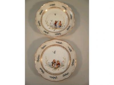 A pair of German porcelain cabinet plates painted to the centre with children