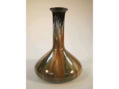 A Bretby pottery bottle vase with streaky glaze in shades of green and