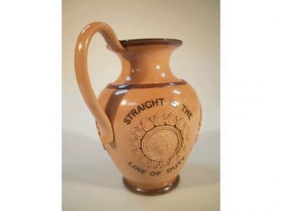 A Doulton Lambeth moral jug with applied sprig medallions and enamelled