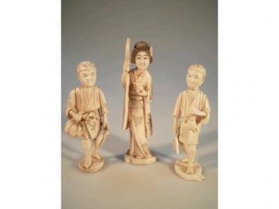 Three Japanese carved ivory okimino figures of two peasant workers
