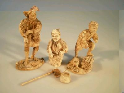 Three carved ivory okimono figures depicting peasant workers