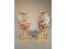 A pair of Capo-di-Monte porcelain baluster vases with triangular plinths
