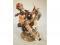 A Capo-di-Monte figure of a painter sat on a rock
