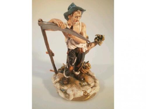 A large Capo-di-Monte figure of Reaper sharpening his scythe