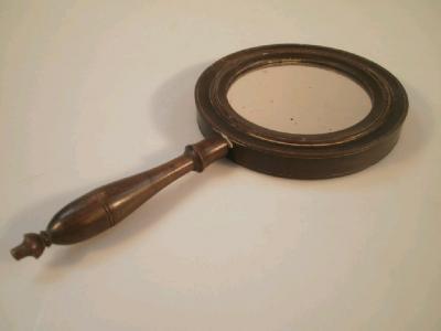 An early 20thC treen hand mirror with turned handle