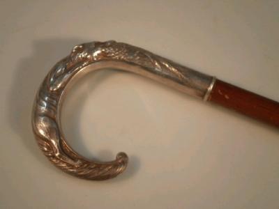 A silver handled walking cane