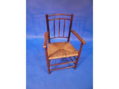 A 19thC spindle back rush seated armchair