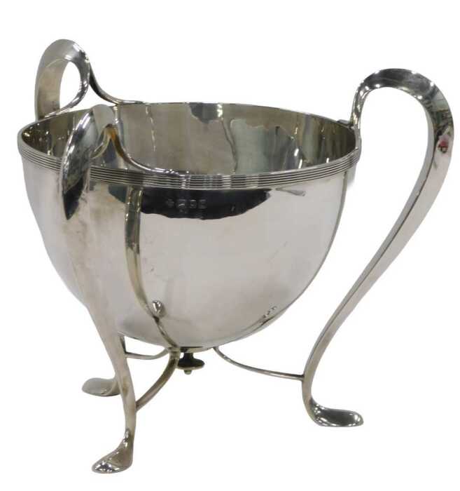 An Edward VII silver Art Nouveau Champagne bucket, by H Wilkinson & Co, on stylised three...