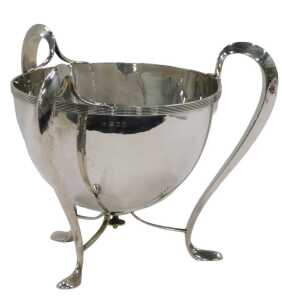 An Edward VII silver Art Nouveau Champagne bucket, by H Wilkinson & Co, on stylised three...
