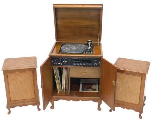A Stereophonic stacking sound system, in walnut finished freestanding cabinet, with two enclosed...