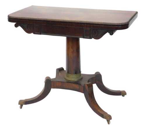 A Regency rosewood fold over card table, the D end top with moulded outline raised above a...
