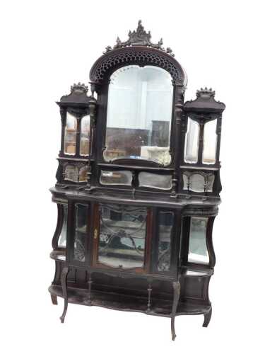 A 19thC mirror back display cabinet, the heavily carved fixed scroll cornice above a frieze, on...