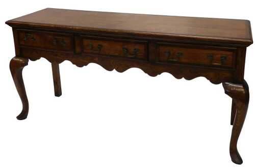 An 18thC style oak dresser base, with a wide cross banding raised above three frieze drawers...