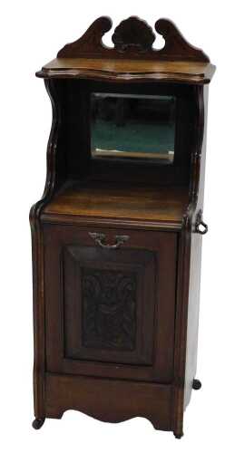 A late 19thC oak coal purdonium, with fixed cornice set with shelf flanked by scrolls, above a...