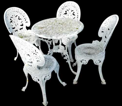 A Victorian style white metal patio table and four chairs, each of heavy pierced scroll design,...