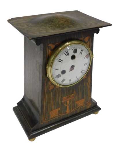 A late 19thC Art Nouveau oak cased mantel clock, set with stylised lotus leaves and other...