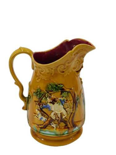 A 19thC style Majolica jug, raised with huntsman with bow and dog in naturalistic setting, on...