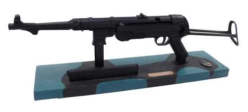 A metal replica German MP40 gun, on plinth base, set with replica Panzer assault badge, 68cm long.