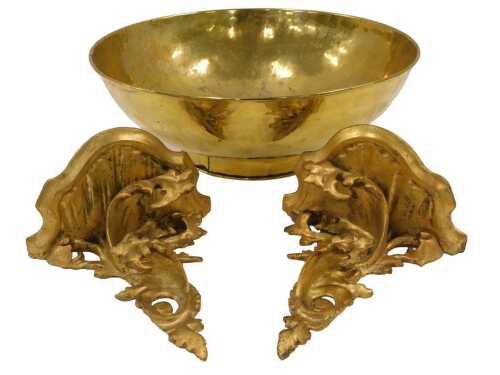 A large brass bowl, of circular form, 34cm diameter, and a pair of wooden rococo style wall...