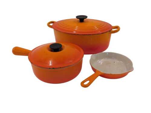 A Le Creuset lidded casserole dish, in orange, 38cm wide, lidded pan and skillet. (3)