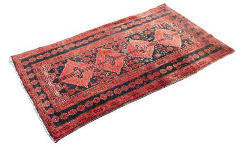 A Middle Eastern style machine woven rug, of rectangular form, the outer field with flower heads...